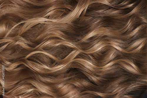 A closeup view of a bunch of shiny curls blond hair