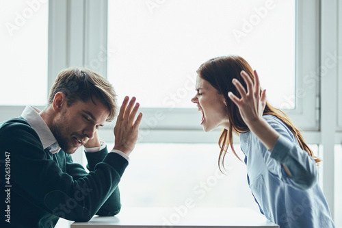 emotional man and woman sitting at the table conflict quarrel communication