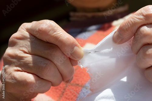 Close-up of the elderly person who sews. 縫物をする高齢者（シニア世代）のクローズアップ 