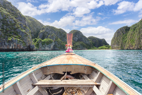 Traditional longtail boat with beautiful scenery view at Maya Bay on Phi Phi Leh Island in sunshine day
