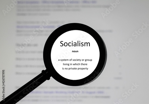 Selective focus on word Socialism, word in a dictionary. Close up of an English dictionary page with the word socialism 