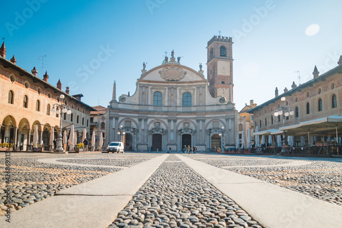 Square of the Cathedral of Sant'Ambrogio (Duomo di Vigevano) by day, blue sky