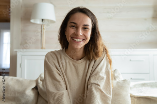 Screen view of happy millennial Hispanic woman look at camera have webcam online digital conference. Portrait of smiling young female speak talk on video call at home. Virtual event concept.