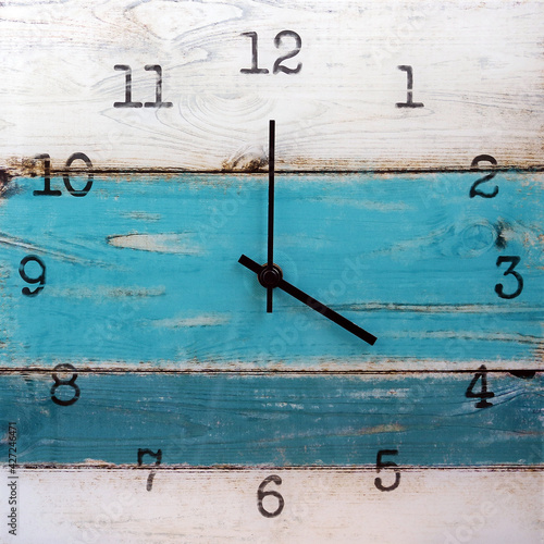 Wooden wall square clock. Four o'clock. Isolated