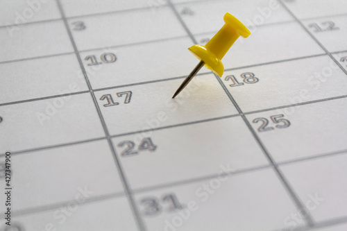 Calendar with pushpin in May 17 to illustrate the new extended date for IRS Federal Income Tax Returns. USA Tax deadline concept