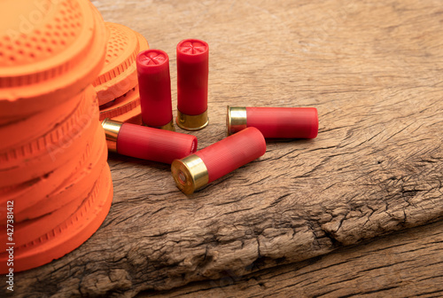 Clay pigeons and shotgun bullets on wooden background , Clay target shooting game , Can be used as a background