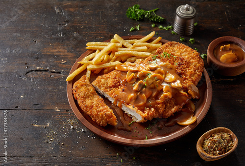 Portion of meat escalope with creamy mushroom sauce