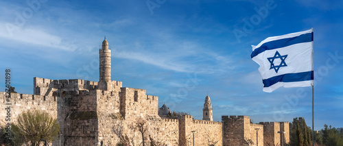 Panorama of Jerusalem Citadel near the Jaffa Gate with Tower of David, ancient fortress walls and Israeli flag