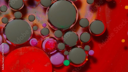 Colorful black red bubbles wallpaper themes background. Multicolor space universe concept. Fantastic hypnotic surface. Abstract pattern chemical reaction texture liquid paint motion bubble in water