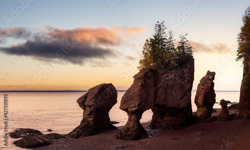Panoramic view of Cape Rocks during a vibrant sunrise. Colorful Sky Art Render. Taken in Hopewell Rocks Park, New Brunswick, Canada.