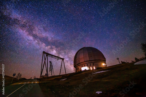 Special astrophysical observatory against starry night sky with milky way