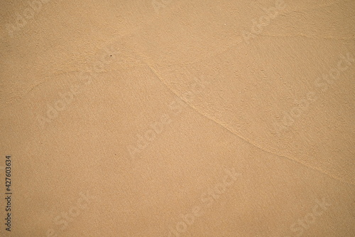 Natural brown sand background, surface and texture.