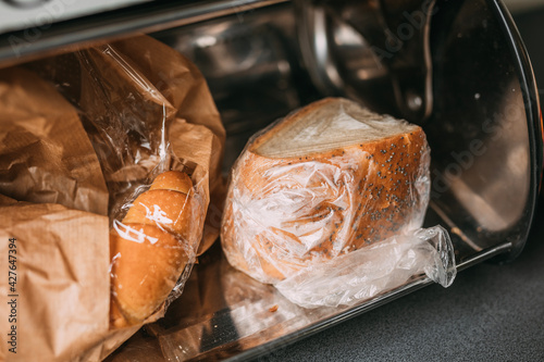 bread in plastic bags in a breadbox, metal bread bin 