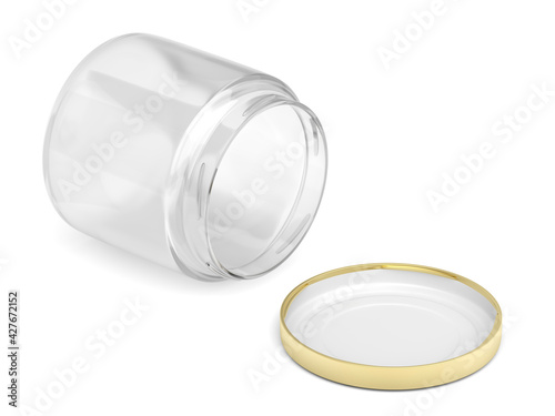 Open glass jar and golden cap on white background