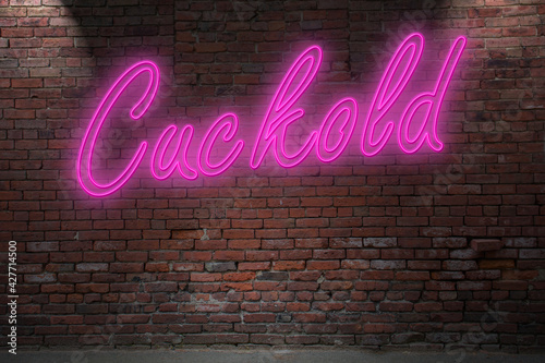 Neon Cuckold lettering on Brick Wall at night
