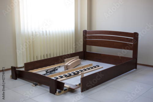 disassembled wooden bed on the floor