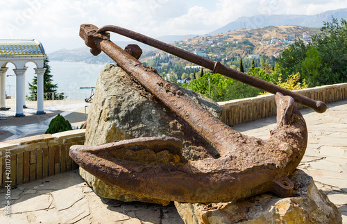 Old ship anchor, Admiralty anchor galley England 1780 is installed on observation deck. Church-lighthouse of St. Nicholas Miracle-Worker of Myra. Malorechenskoye, Crimea, Russia - October 01, 2019