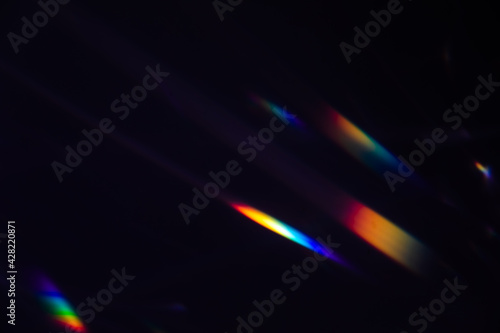 Blur colorful warm rainbow crystal light leaks on black background. Defocused abstract retro film analog effect for using over photos as overlay or screen filter