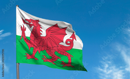 Flag of Wales with red dragon waving against blue sky, Cardiff