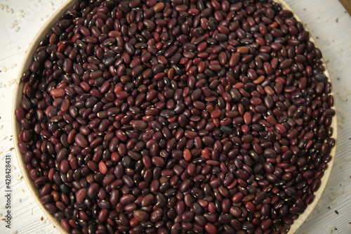 Pile Of Raw Red Organic Kidney Beans Rotating Top view. Soft focus. On a wooden table.