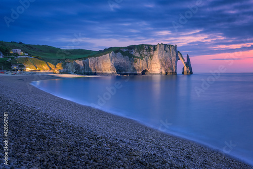 The chalk cliffs of Etretat after the sunset. Etretat, Normandy, France