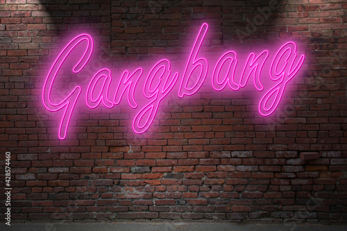 Neon Gangbang lettering on Brick Wall at night