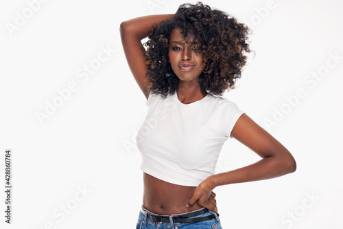 Attractive young black woman playing with her afro isolated on white background