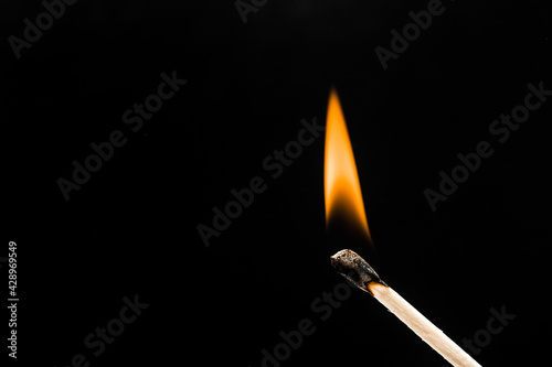 burning match on black background - Image
