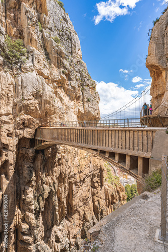 People crossing the suspension bridge in Royal Trail (El Caminito del Rey) in gorge Chorro, Malaga province.