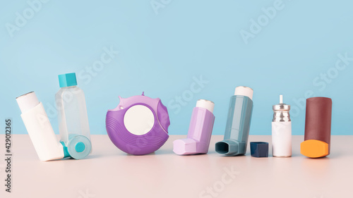 Set of asthma inhalers for asthma and COPD patients on table. Pharmaceutical product is used to treat lung inflammation and prevent asthma attack symptoms. Health care and medical concept. Copy space.