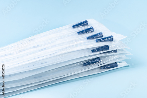 Rusch male and female all purpose catheter on blue background, straight tipped intermittent catheters designed for a single use, packaged individually and sterile, 8 inch