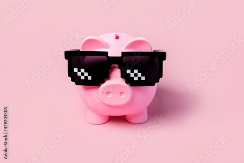 Pink piggy money bank with black sunglasses