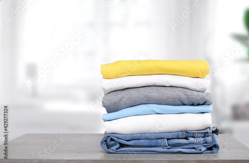 Stack of cotton colorful clothes on table indoors.Stacked apparel.Folded clean clothing.