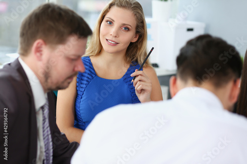 Group of men and women discussing in office