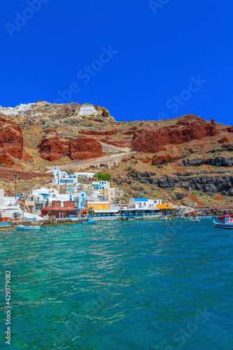 Greece Santorini island in Cyclades, Ammoudi village with fishing boats
