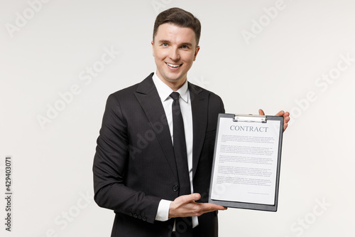 Young happy employee business corporate lawyer man in classic formal black grey suit shirt tie work in office hold clipboard with paper document contract agreement isolated on white background studio.