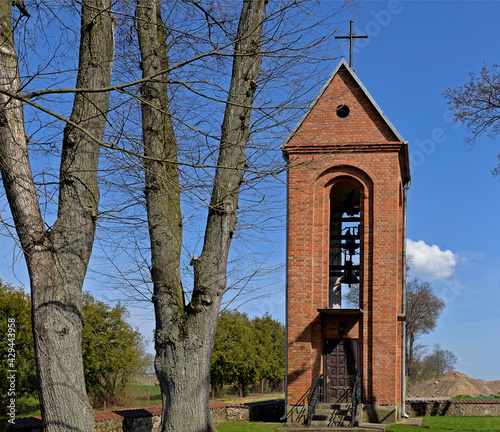 The belfry and its architectural details located next to the Gothic-style Catholic church of St. st. Maciej in the village of Pawłowo in Masovia, Poland.