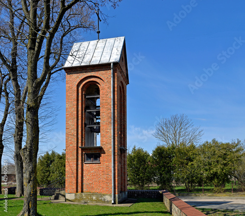 The belfry and its architectural details located next to the Gothic-style Catholic church of St. st. Maciej in the village of Pawłowo in Masovia, Poland.