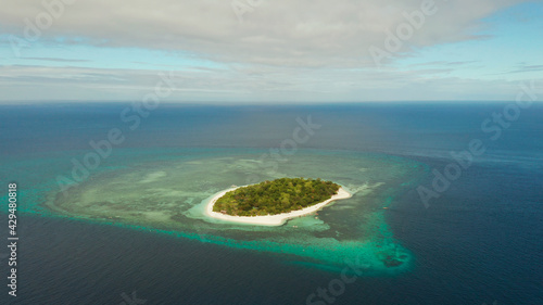 Beautiful beach on tropical island surrounded by coral reef, top view. Mantigue island. Small island with sandy beach. Summer and travel vacation concept, Camiguin, Philippines, Mindanao
