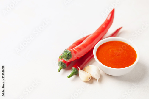 Freshly Sriracha Hot chilli Sauce in bowl on the table. Copy space.