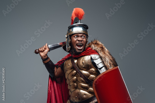 Violent roman warrior in fight pose with sword