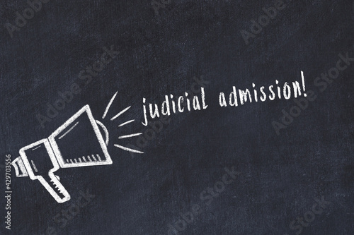 Chalk loudspeaker and inscription judicial admission on black chalkboard