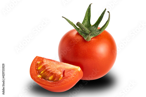 Side view a whole and a piece of cherry tomato on white background. Tomatoes or Solanum lycopersicum or lycopersicon esculentum are source of antioxidant lycopene which reduce risk of heart disease.