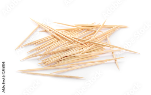 Heap of wooden toothpicks on white background