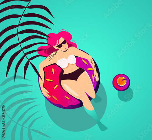 A girl on an inflatable ring in the form of a donut is resting in a tropical paradise, next to a tropical cocktail on an inflatable ring. Vacation concept, summer.