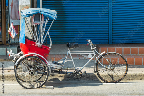 Old bike rickshaw rikshaw trishaw in Don Mueang Bangkok Thailand.