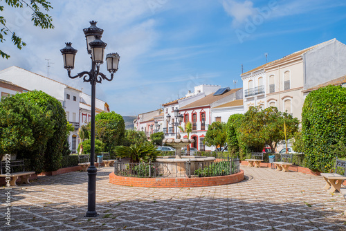 central square with a fountain and a church in a town of Almargen in Malaga Andalusia