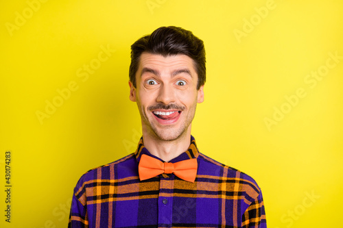 Photo of young excited man happy positive smile lick teeth yummy delicious isolated over yellow color background