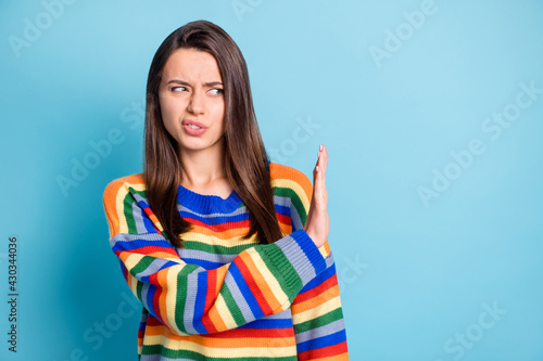 Photo portrait of disgusted unhappy woman grimacing curious looking blank space rejecting refusing isolated on bright blue color background