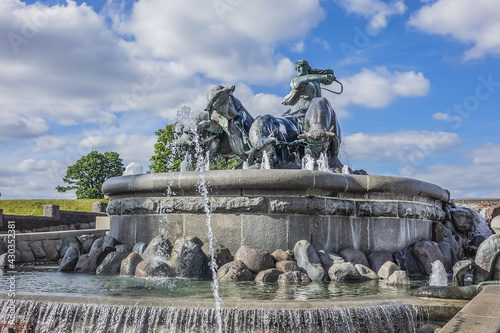 View of famous Gefion Fountain (Gefionspringvandet, 1899) in Copenhagen. Gefion Fountain depicting legendary Norse goddess driving four oxen. It designed by Danish artist Anders Bundgaard. Denmark.